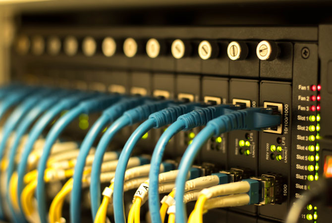 Fiber Optic cables and UTP Network cables connected hub ports.